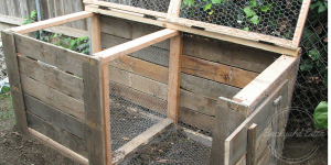 This is my compost, built from plans found online. It is still empty in the picture but ready to fill with layers of the four compost ingredients. Fill one side until full and then start filling the next half. Photo: Backyard-Eden.com